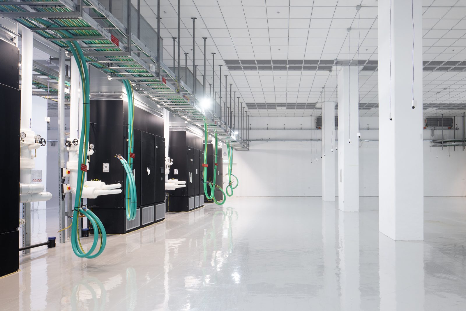 Cooling units and piping along the data hall