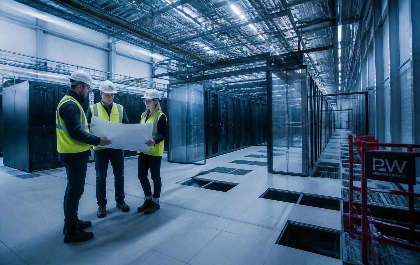 Golmat engineers reviewing drawings inside a data centre under construction